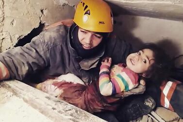 A rescue officer pulls 2.5-year-old Nusra out of the rubble of a building that collapsed in Elazig following January 24's earthquake. AFP
