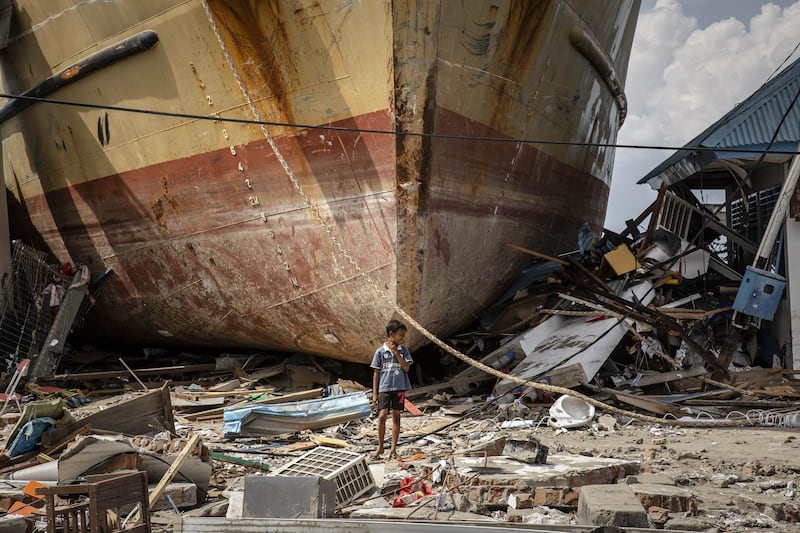 A boy stands in front of a stranded ship after a deadly tsunami struck the area of Donggala, Central Sulawesi, Indonesia. Ulet Ifansasti/Getty Images