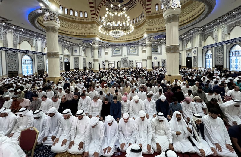 Worshippers perform Eid prayers at the mosque. Pawan Singh / The National