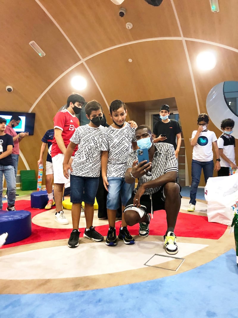 Pogba poses for pictures during his visit.