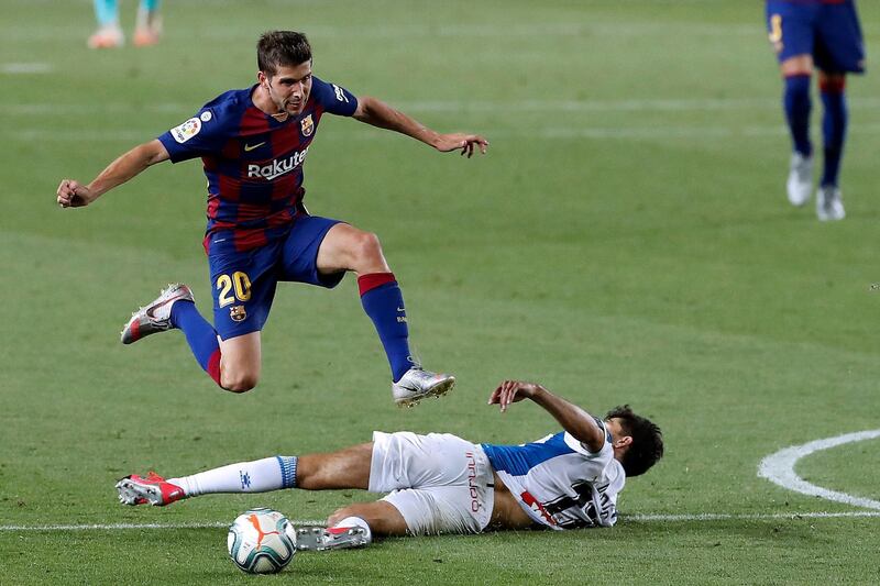 Barcelona's Sergio Roberto jumps over Espanyol's Didac Vila. EPA
