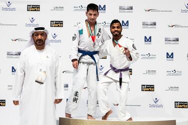 UAE's Hamad Eissa Al Balooshi, right, defeated Ildar Zainalov, centre, to win para jiu-jitsu gold in the JJIF World Championship at the Mubadala Arena on Tuesday. Courtesy UAEJJF