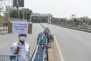 A traffic policeman advises commuters to stay home during the first day of a 21-day government-imposed nationwide lockdown as a preventive measure against the Covid-19 coronavirus, in Hyderabad on March 25, 2020. AFP