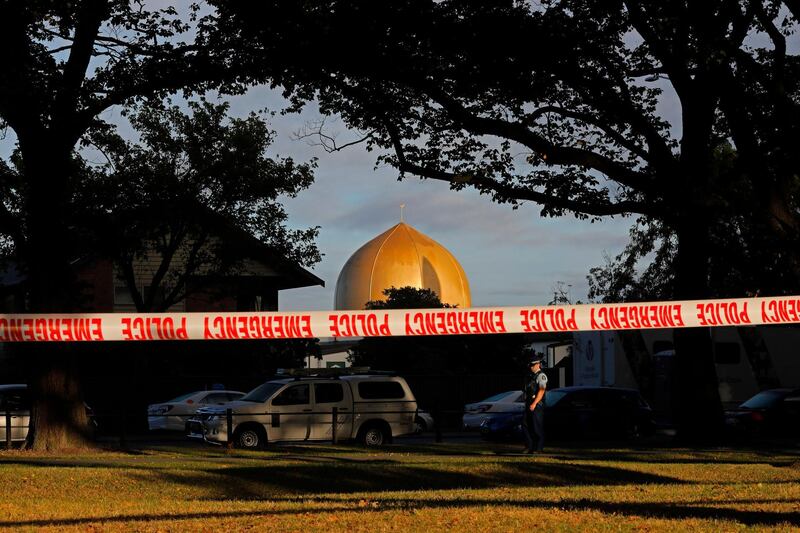 FILE - In this March 17, 2019, file photo a police officer stands guard in front of the Masjid Al Noor mosque in Christchurch, New Zealand, where one of two mass shootings occurred. Facebook will work with law enforcement organizations to train its machine learning technology to recognize videos of violent events as part of a broader effort to crack down on extremism. The move comes after its artificial intelligence did not detect the first-person video of a terrorist attack on the mosque in Christchurch. (AP Photo/Vincent Yu, File)