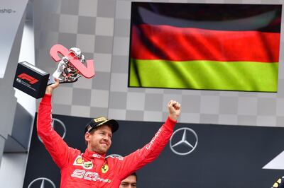 CORRECTION / Ferrari's German driver Sebastian Vettel celebrates with the trophy on the podium after the German Formula One Grand Prix at the Hockenheim racing circuit on July 28, 2019 in Hockenheim, southern Germany.  / AFP / Andrej ISAKOVIC

