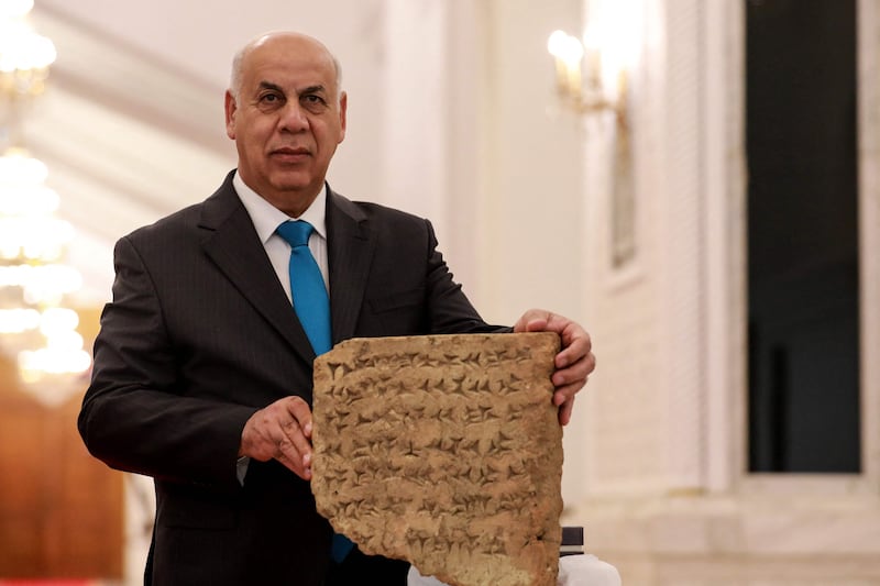 Iraqi Culture Minister Ahmed Fakak Al Badrani displays the 2,800-year-old stone tablet at a press conference in Baghdad. AFP