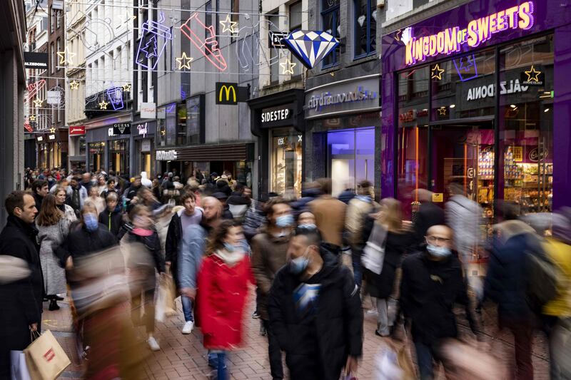 Shoppers wear face masks in central Amsterdam, the Netherlands. The country has seen a surge in Covid-19 cases, which hit a record on Thursday, November 11. AFP