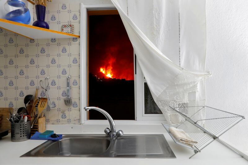 Lava is seen through the window of a kitchen in El Paso. Photo: Reuters