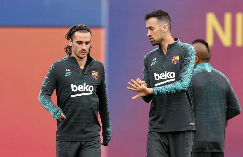 Barcelona's Antoine Griezmann and Sergio Busquets. Reuters