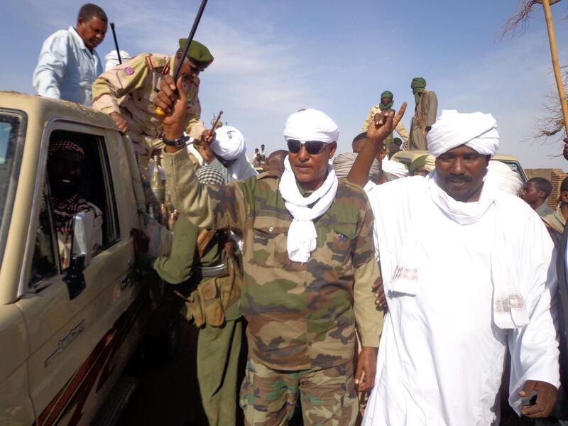 (FILES) This file photo taken on December 07, 2013 shows Musa Hilal (C), the leader of the Arab Mahamid tribe in Darfur, saluting his followers upon his arrival in Nyala.
Hilal, a former aide to President Omar al-Bashir, was arrested in November 2017 by Sudan's counter-insurgency forces near his hometown of Mustariaha in North Darfur state after fierce clashes that left several dead.
 / AFP PHOTO / -