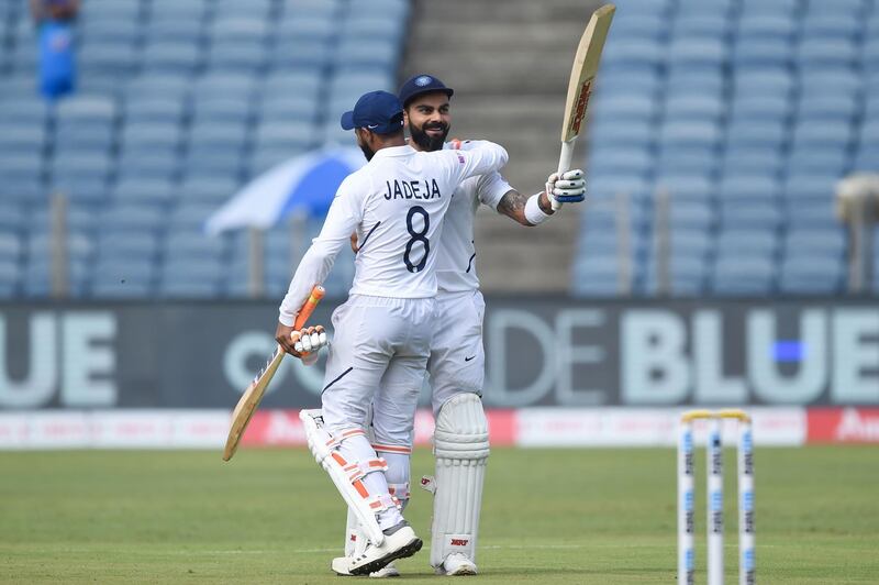 India's cricket team captain Virat Kohli, right, celebrates with teammate Ravindra Jadeja after scoring a double century. AFP