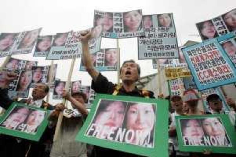 South Korean protesters shout slogans during a rally demanding release of American journalists detained in North Korea, at a park in Seoul, South Korea, Tuesday, June 9, 2009. The sentencing of two American journalists to 12 years in a North Korean labor prison sets the stage for possible negotiations with the reclusive nation for their release _ perhaps involving an envoy from the United States. (AP Photo/Ahn Young-joon) *** Local Caption ***  SEL105_South_Korea_North_Korea_Journalists_Held.jpg *** Local Caption ***  SEL105_South_Korea_North_Korea_Journalists_Held.jpg