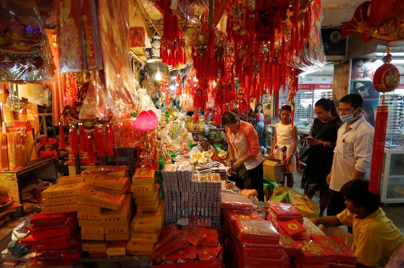 People in Phnom Penh, Cambodia, look at items for the upcoming Chinese New Year. EPA