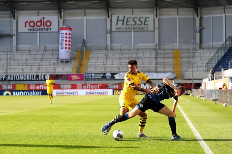 Jadon Sancho battles for the ball with Sebastian Schonlau on Sunday. EPA