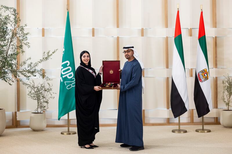 President Sheikh Mohamed presents a Zayed the Second Medal to Thuraya Gargash