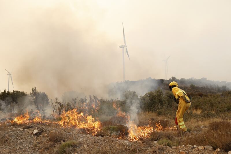 Firefighters battle a wildfire in Bejis, Castellon, Spain. EPA