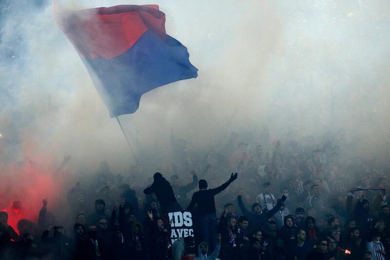 Paris Saint Germain supporters set off smoke grenades during their Champions League last-16 tie against Real Madrid in Paris.  Yoan Valat / EPA