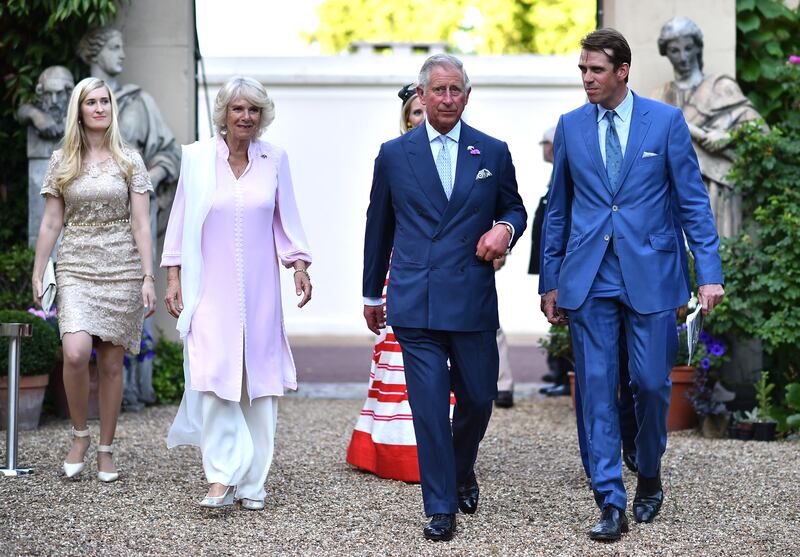 Britain's Camilla, Duchess of Cornwall, Prince Charles and Ben Elliot arrive at a reception in London. AFP