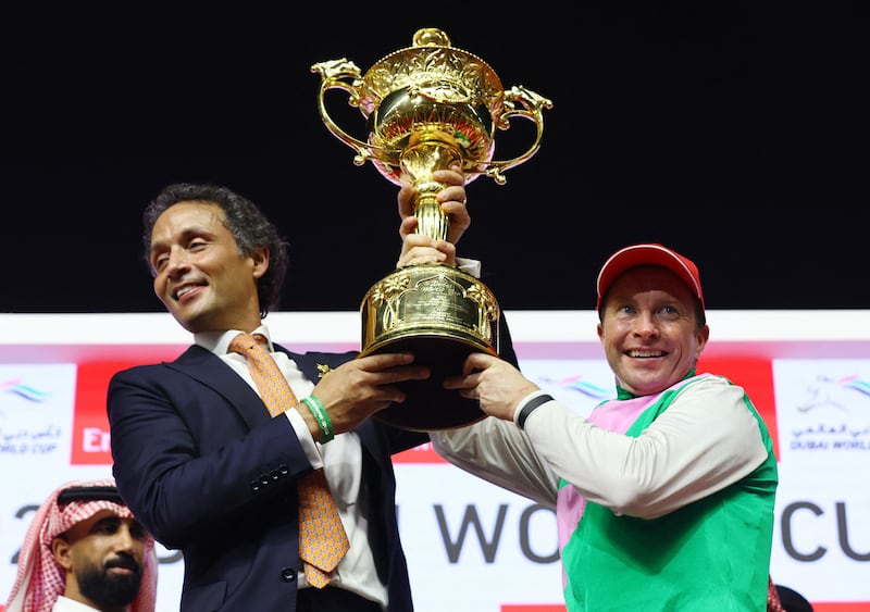 Trainer Bhupat Seemar and jockey Tadhg O'Shea celebrate with the trophy after Laurel River won the $12 million Dubai World Cup at Meydan on Saturday, March 30, 2024. Reuters