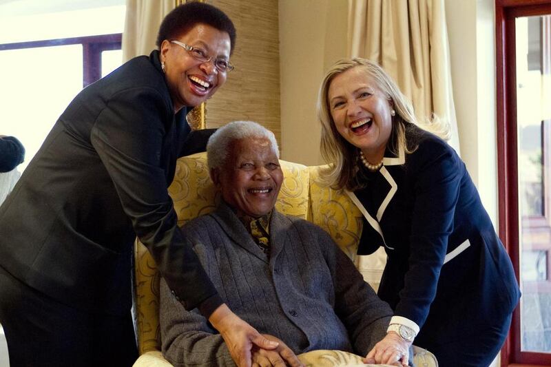 Then US Secretary of State Hillary Clinton with Mandela and his wife Graca Machel at his home in Qunu in this August 6, 2012 file photo. Jacquelyn Martin / Pool