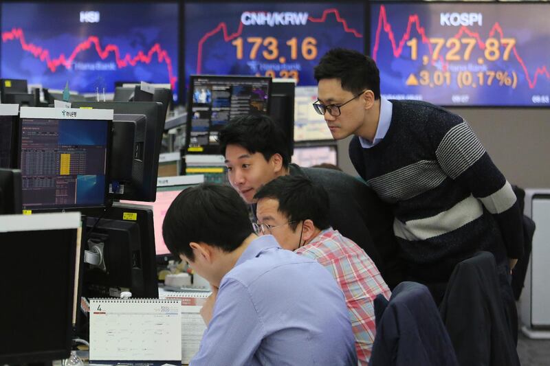 Currency trader watch monitors at the foreign exchange dealing room of the KEB Hana Bank headquarters in Seoul, South Korea, Friday, April 3, 2020. Asian stocks were mixed Friday after Wall Street gained for the first time in three days on stronger oil prices despite enduring uncertainty about how long the global economic decline due to the coronavirus pandemic will last. (AP Photo/Ahn Young-joon)