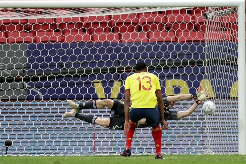 Argentina goalkeeper Emiliano Martinez saves a penalty shot by Colombia's Yerry Mina.
