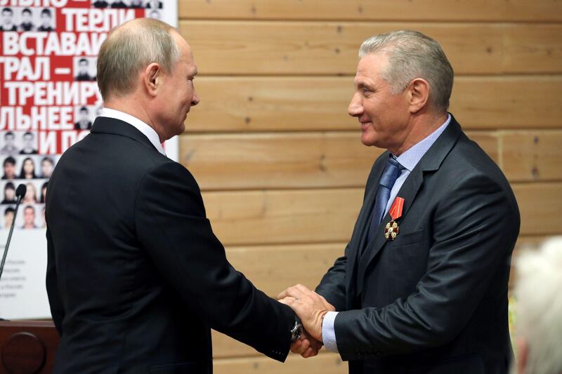 Russia's President Vladimir Putin gives Boris Rotenberg a state award at a judo club. Photo: Itar-Tass News Agency/Alamy Live News