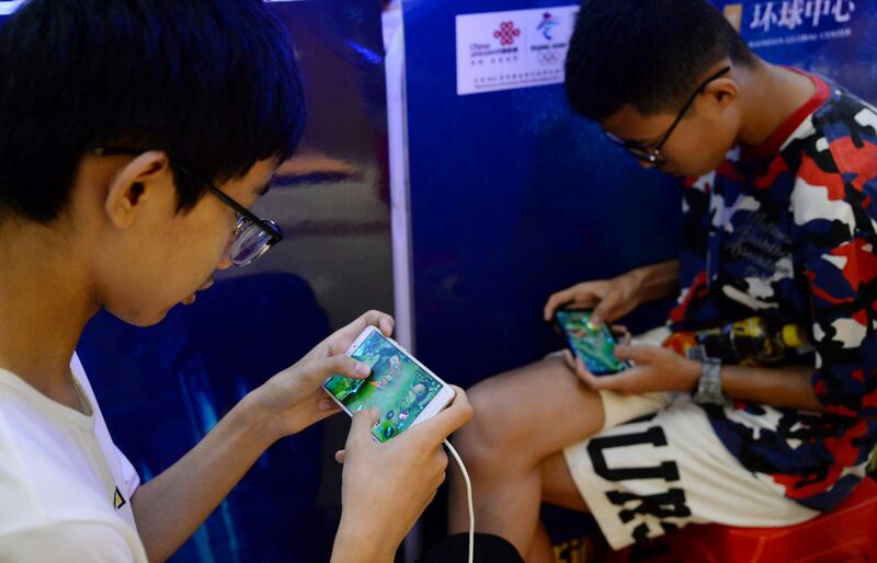 Boys  playing 'Honour of Kings' by Tencent. The Chinese company posted revenue growth from PC and mobile games in the second quarter of 2023. Reuters