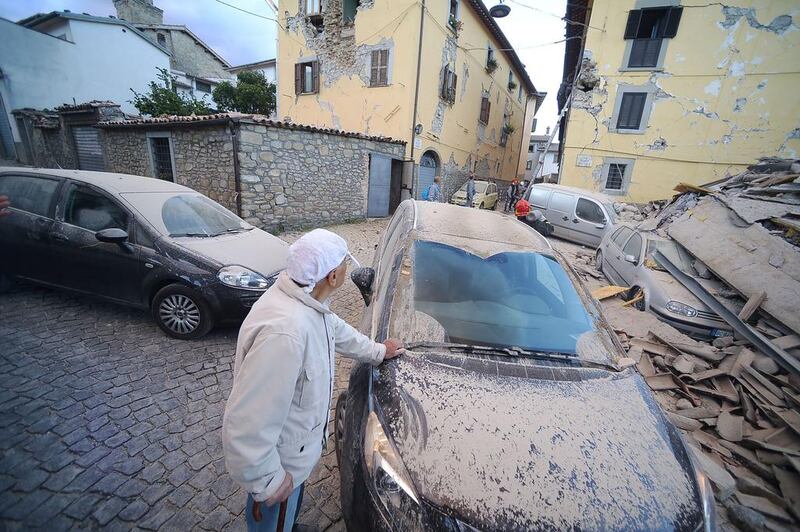 A man looks at damaged buildings after a strong heartquake hit Amatrice. Central Italy was struck by a powerful, 6.2-magnitude earthquake in the early hours, which has devastated dozens of mountain villages. Filippo Monteforte / AFP
