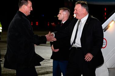 Secretary of State Mike Pompeo is greeted by US ambassador to Germany Richard Grenell on arrival at Munich airport. Andrew Caballero-Reynolds / Pool via AP