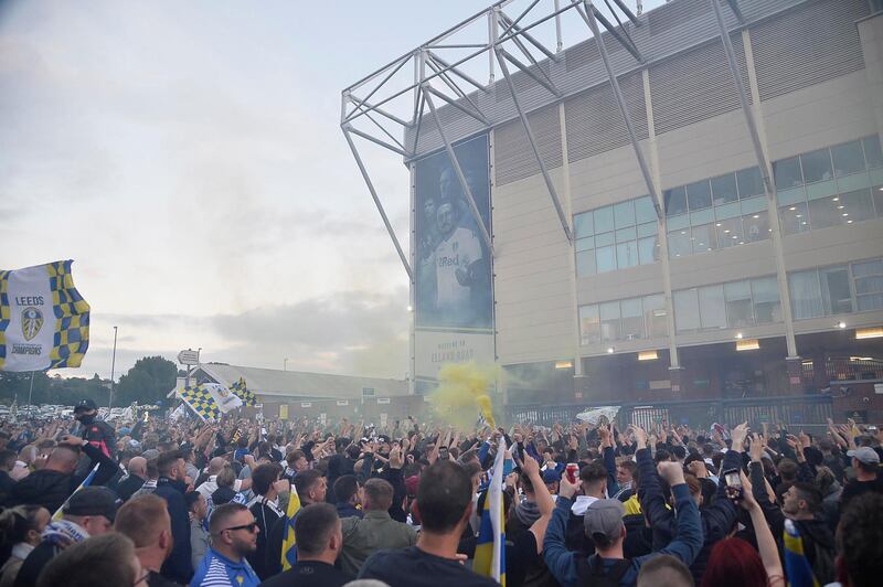 Leeds United fans outside Elland Road celebrate winning the Championship. EPA