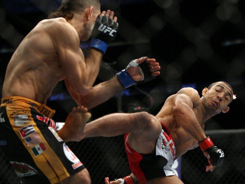 Jose Aldo, right, and Ricardo Lamas fight during their featherweight championship bout on Saturday. Aldo won by unanimous decision. Tim Larsen / AP