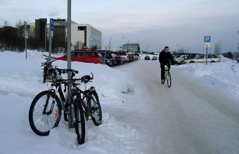 FILE - In this undated file photo, a cold winter's day in Tromsoe, the main city of Norway's Arctic. Sitting about 70 Km (43 miles) west of Tromsoe, the island of Sommaroey, north of the Arctic Circle, has a population of about 350 people and fishery and tourism are the main industry.  People on the remote island of Sommaroey, north of the Arctic Circle, on June 13, 2019, have asked Norwegian lawmaker if they can become the world's first time-free zone, getting rid of traditional business opening hours and introduce flexibility in school and working hours because the sun doesn't set for 69-days from May 18 to July 26. (AP Photo / Doug Mellgren, FILE)