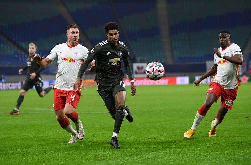 (L-R) Leipzig's Hungarian defender Willi Orban, Manchester United's English striker Marcus Rashford and Leipzig's French defender Nordi Mukiele vie for the ball during the UEFA Champions League Group H football match RB Leipzig v Manchester United in Leipzig, eastern Germany, on December 8, 2020. / AFP / POOL / ANNEGRET HILSE
