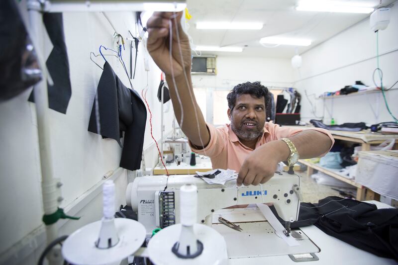A tailor tends his shop at Meena Bazaar in the Bur Dubai area, Dubai on July 20.