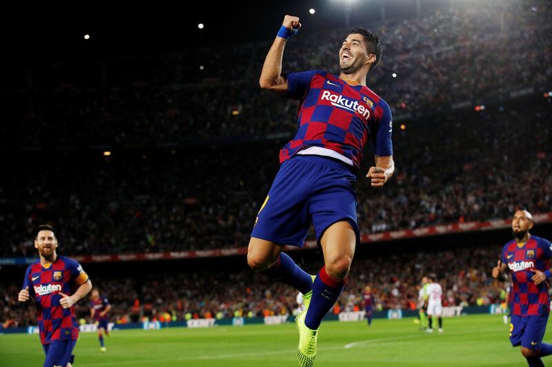 Luis Suarez jumps in the air in celebration. Reuters