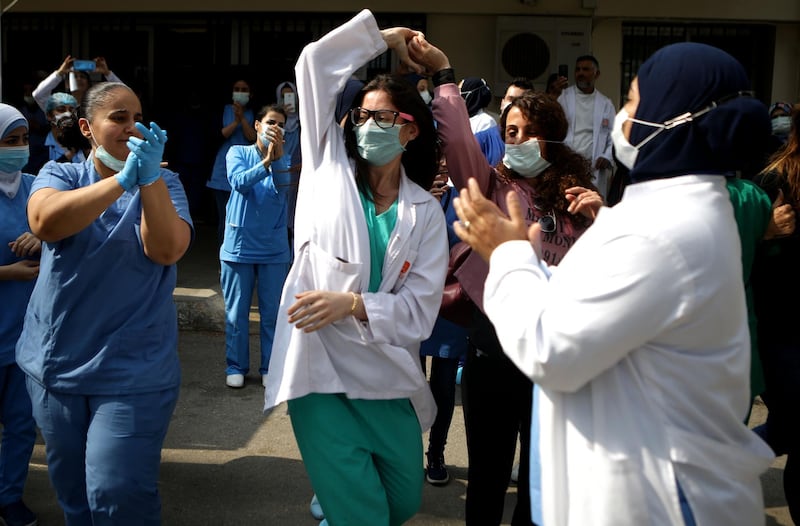 Staff of a Lebanese government hospital dance to music played by a band thanking them for their efforts. AFP