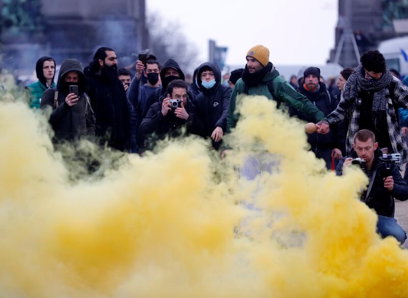 Yellow smoke billows from a flare thrown during the clashes. EPA