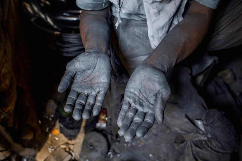 Tarno shows his hand covered by metal from polishing pans at a workshop in Yogyakarta, Indonesia. Up to 100,000 Indonesian workers took to the streets to celebrate the country's first ever Labour Day. Ulet Ifansasti / Getty Images