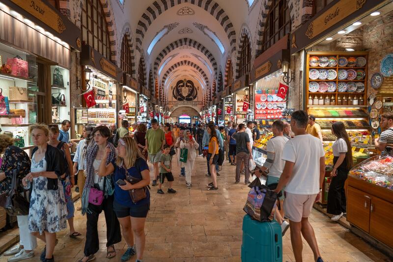 Tourists inside the Grand Bazaar in Istanbul, Turkey. Despite a strong rebound in the country's tourism industry, Fitch estimates that higher energy prices and weaker external demand will result in a current account deficit of 5.1% of gross domestic product in 2022. Photo: Bloomberg
