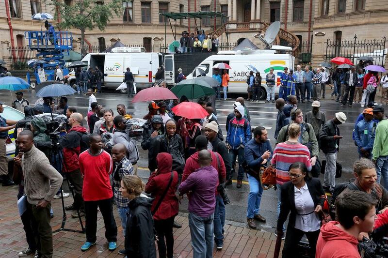 The media mill outside North Gauteng High Court in Pretoria, South Africa, on March 3, 2014, as Oscar Pistorius slips into the building another way to stand trial for the death of his girlfriend Reeva Steenkamp.