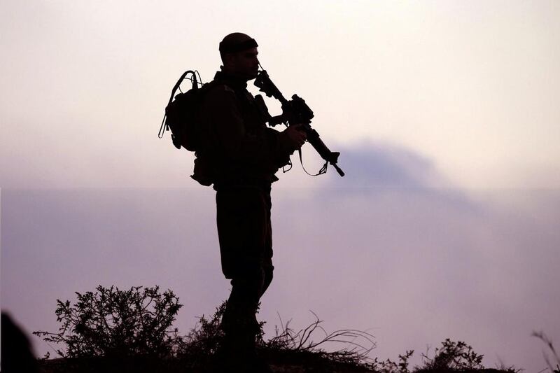 An Israeli soldier keeps his position near Israel's border with the Gaza Strip on July 29, 2014. The Israeli offensive, which began on July 8 to end Hamas rocket attacks on the Jewish state, has killed nearly 1,200 Palestinians, dealing a blow to Israel's public relations campaign. Jack Guez/AFP Photo