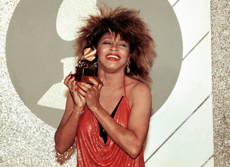 Turner holds up her Grammy Award in 1985 in Los Angeles. AP