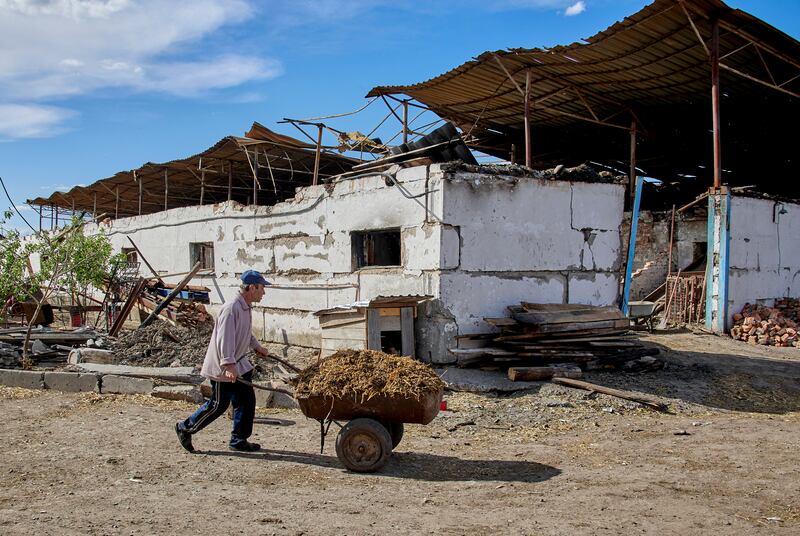 A man works on a damaged farm in the village of Mala Rohan, near Kharkiv, Ukraine. EPA