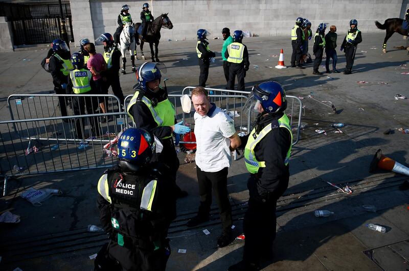 A person is detained during a demonstration in Trafalgar Square against the lockdown imposed by the government, following the outbreak of the coronavirus disease (COVID-19), in London,.  Reuters