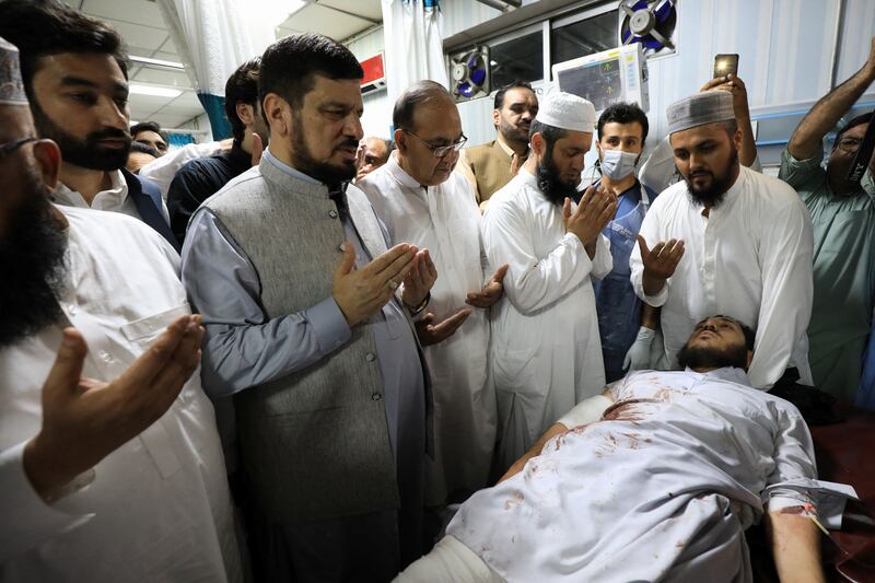 Governor of Khyber Pakhtunkhwa province, Haji Ghulam Ali, prays while visiting an injured man in hospital in Peshawar, Pakistan. Reuters