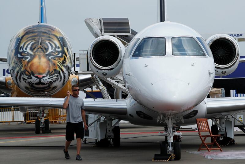An Embraer E-190 E2 aircraft featuring a spray painted tiger face on the nose of the aircraft is displayed during a media preview of the Singapore Airshow February 4, 2018. REUTERS/Edgar Su