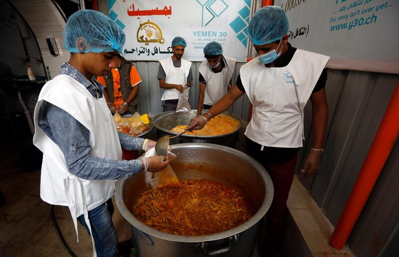 Volunteers prepare food to be given to those in need in Sanaa. EPA