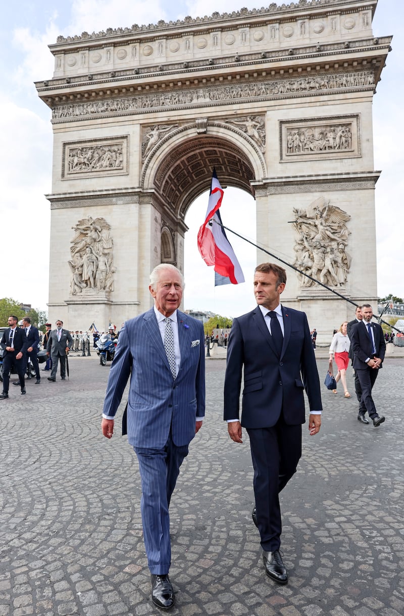 King Charles and Mr Macron during the welcoming ceremony. Reuters