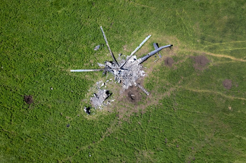 The wreckage of a Russian helicopter in a bomb-cratered field in Biskvitne, May 2022. Getty Images